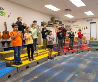 Students standing on colorful flipFORMS risers